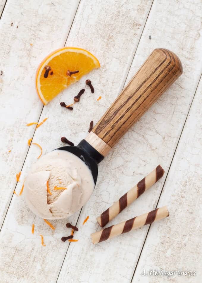 A ball of Boozy Orange ICe Cream  melting on a scoop