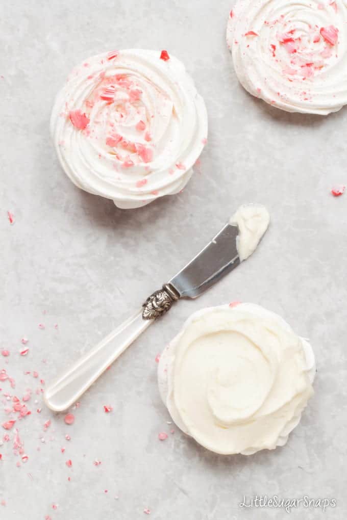 Spreading white chocolate ganache onto Meringue swirls