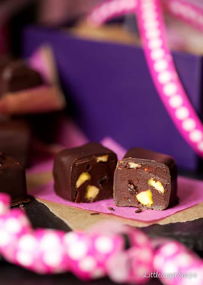 A cut in half Caramel Truffle with fruit and nut inside