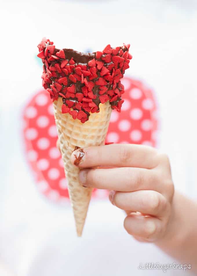 Child holding a chocolate dipped ice cream cone