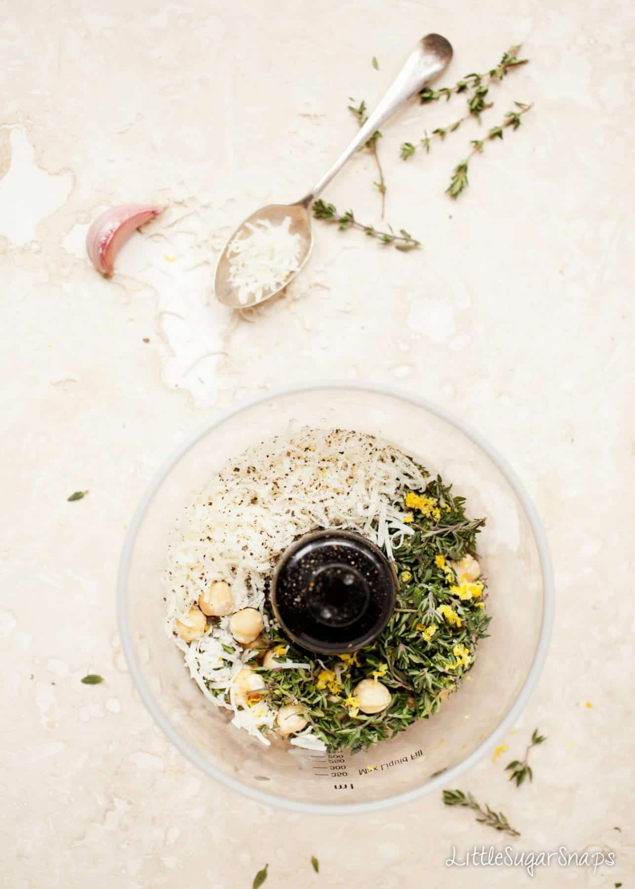 Ingredients for homemade pesto in the bowl of a food processor.