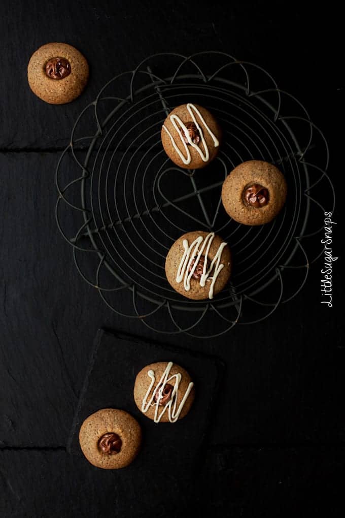 Flatlay of Nutella thumbprint cookies arranged artistically on a wire rack