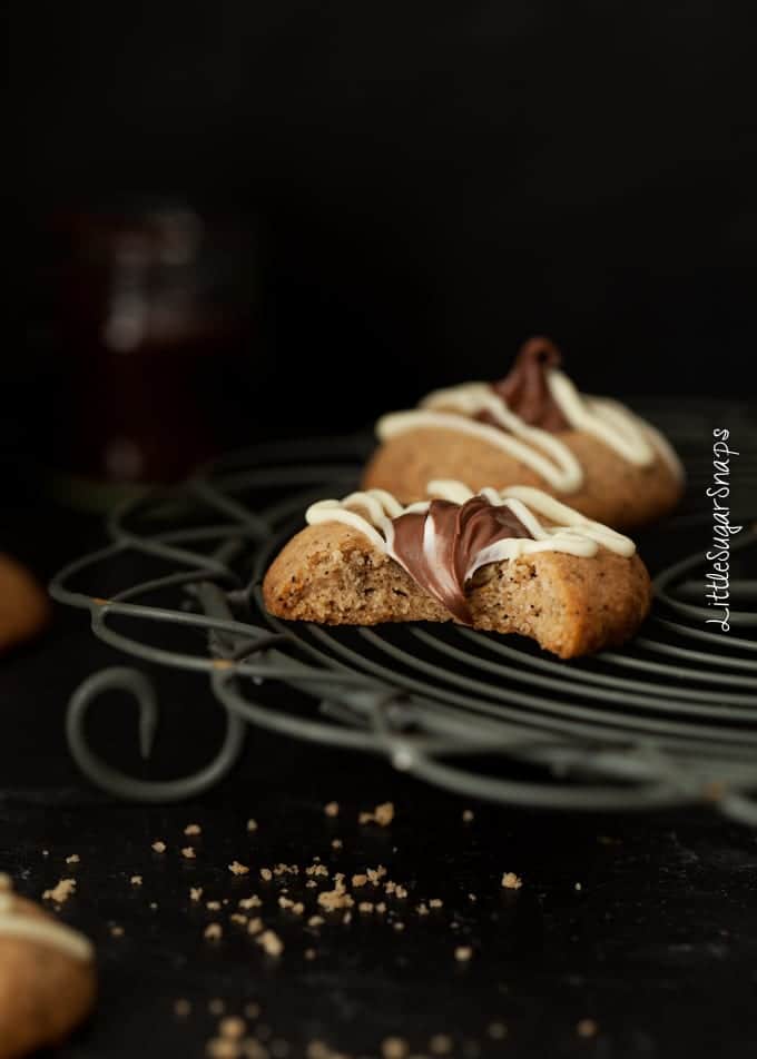 Bitten into Nutella thumbprint cookie on a wire rack