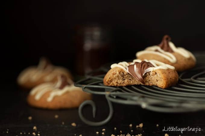 Bitten into chocolate  thumbprint cookie on a rack