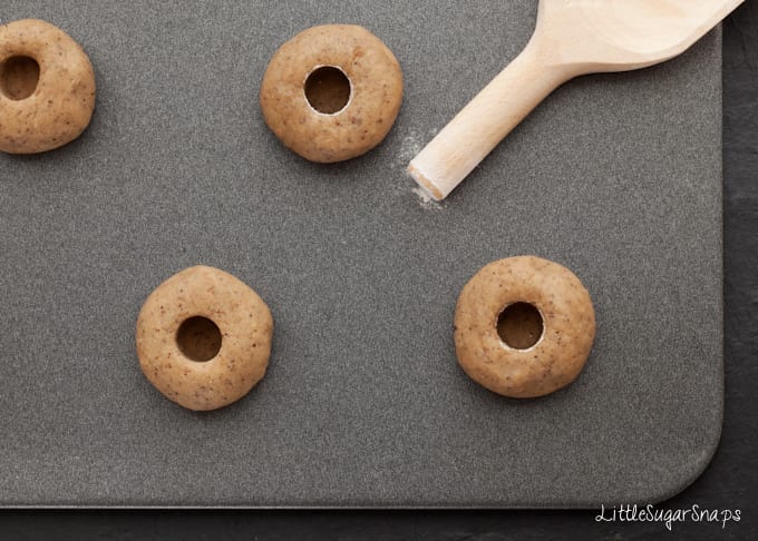 Using the end of a wooden spoon to make a thumbprint cookie