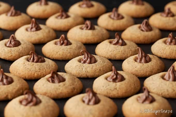 Rows of thumbprint cookies on a baking sheet