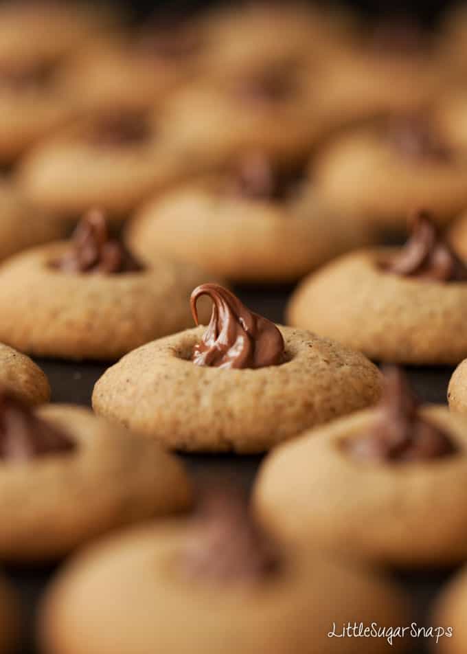 Close up of a thumbprint cookie filled with nutella