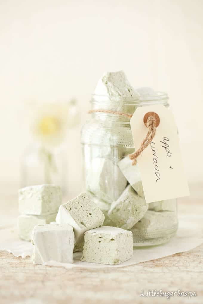 A jar of Apple and cinnamon marshmallows with chunks on the side