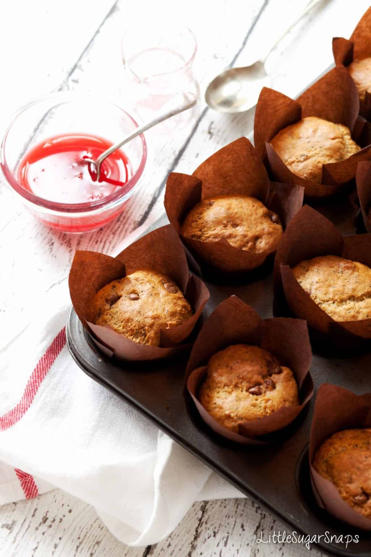 Chocolate orange muffins in a baking tin.