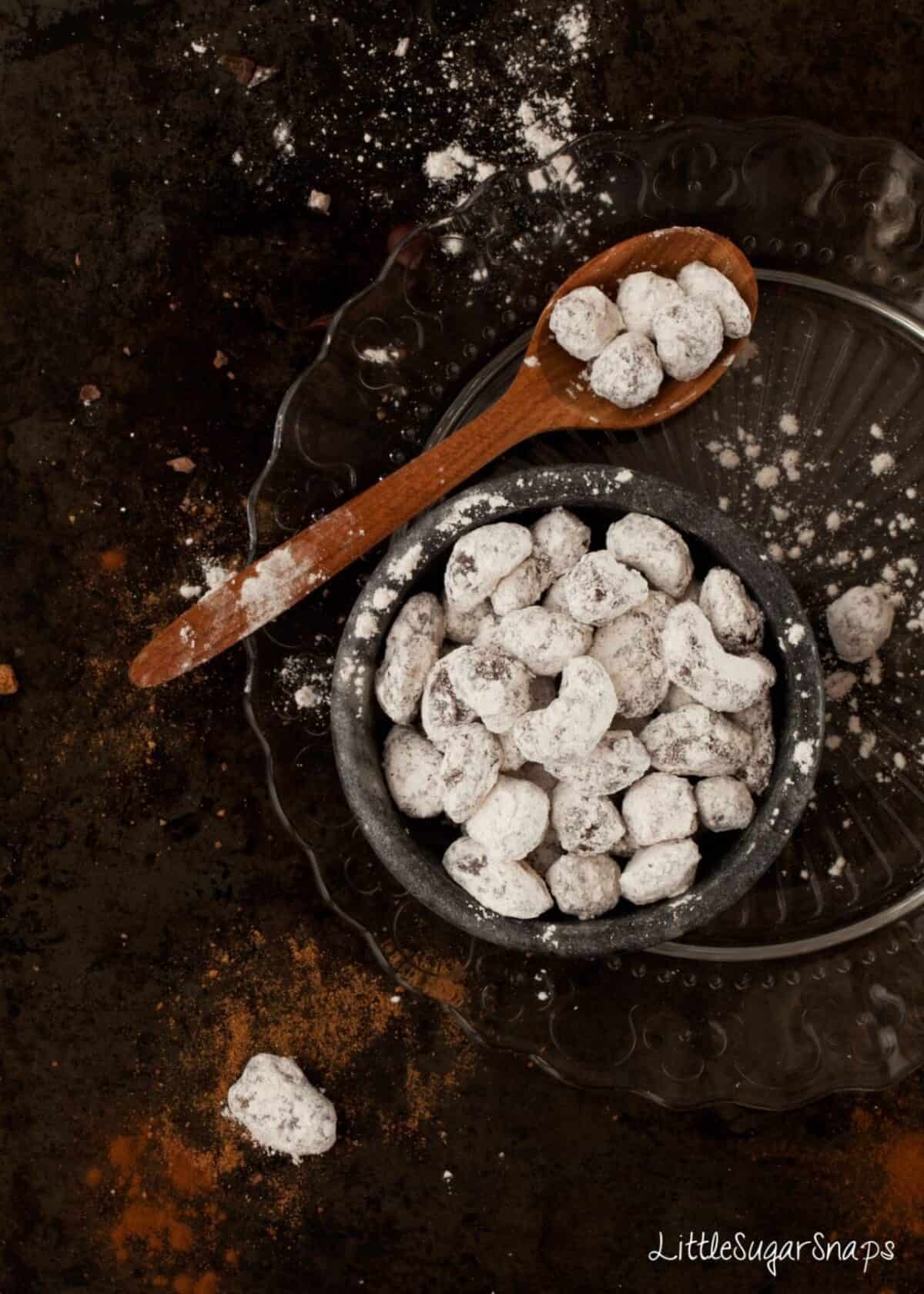 Chocolate covered nuts that have been dusted in icing sugar