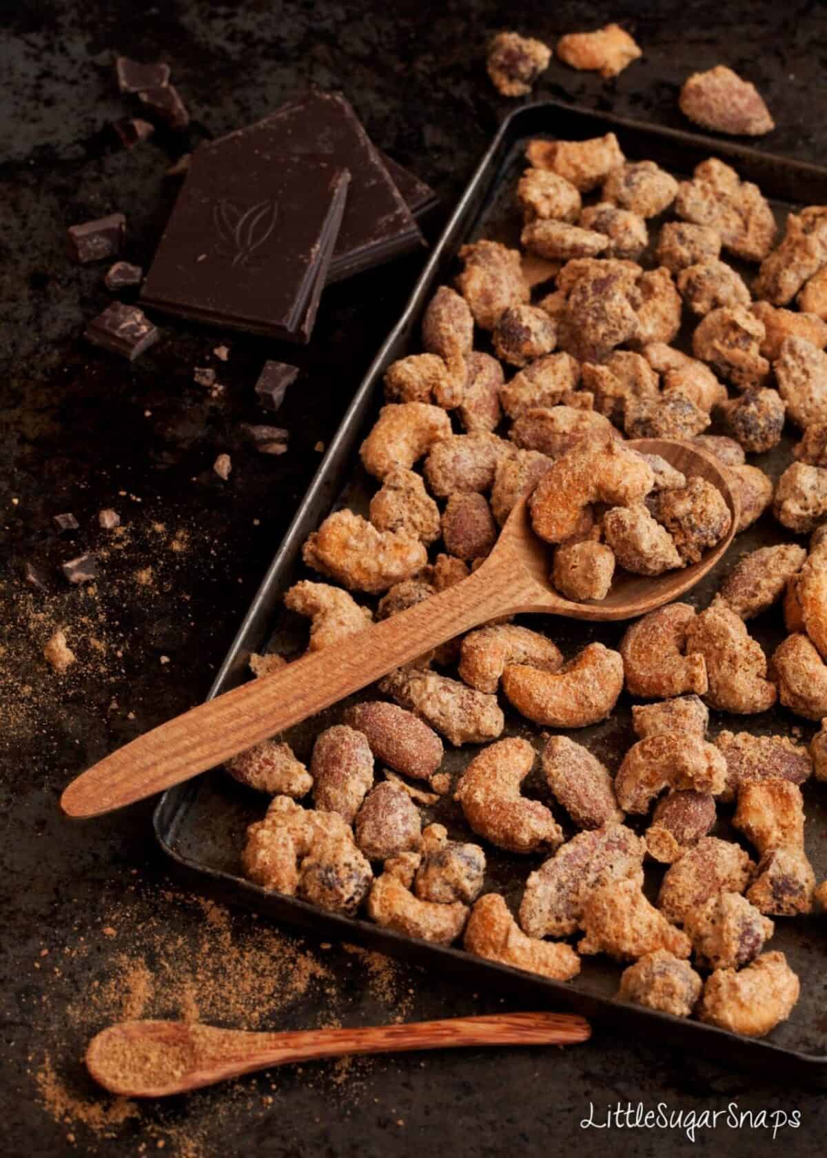 chai spiced nuts freshly baked on a baking tin.