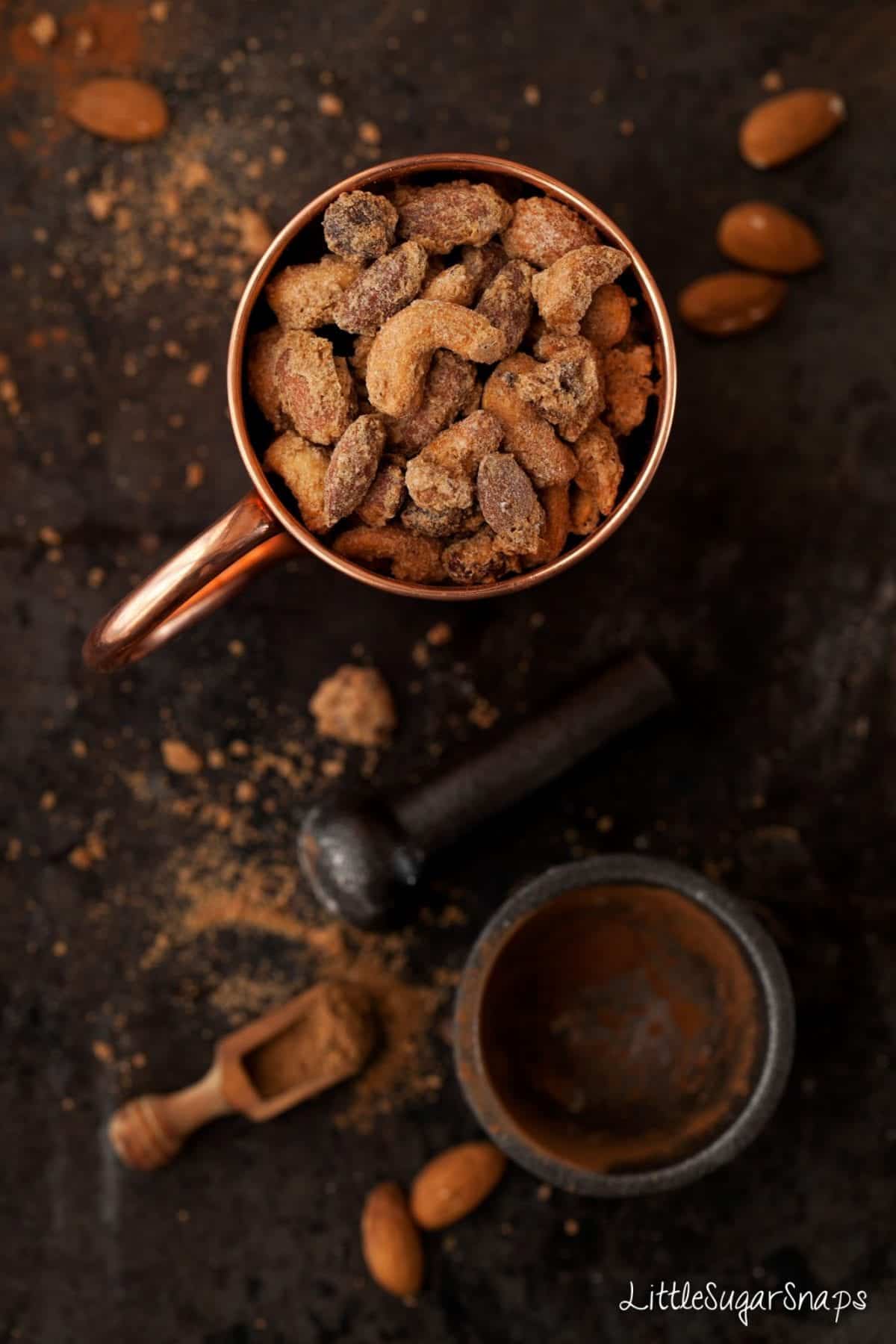 Chai spiced candied nuts in a copper mug. 