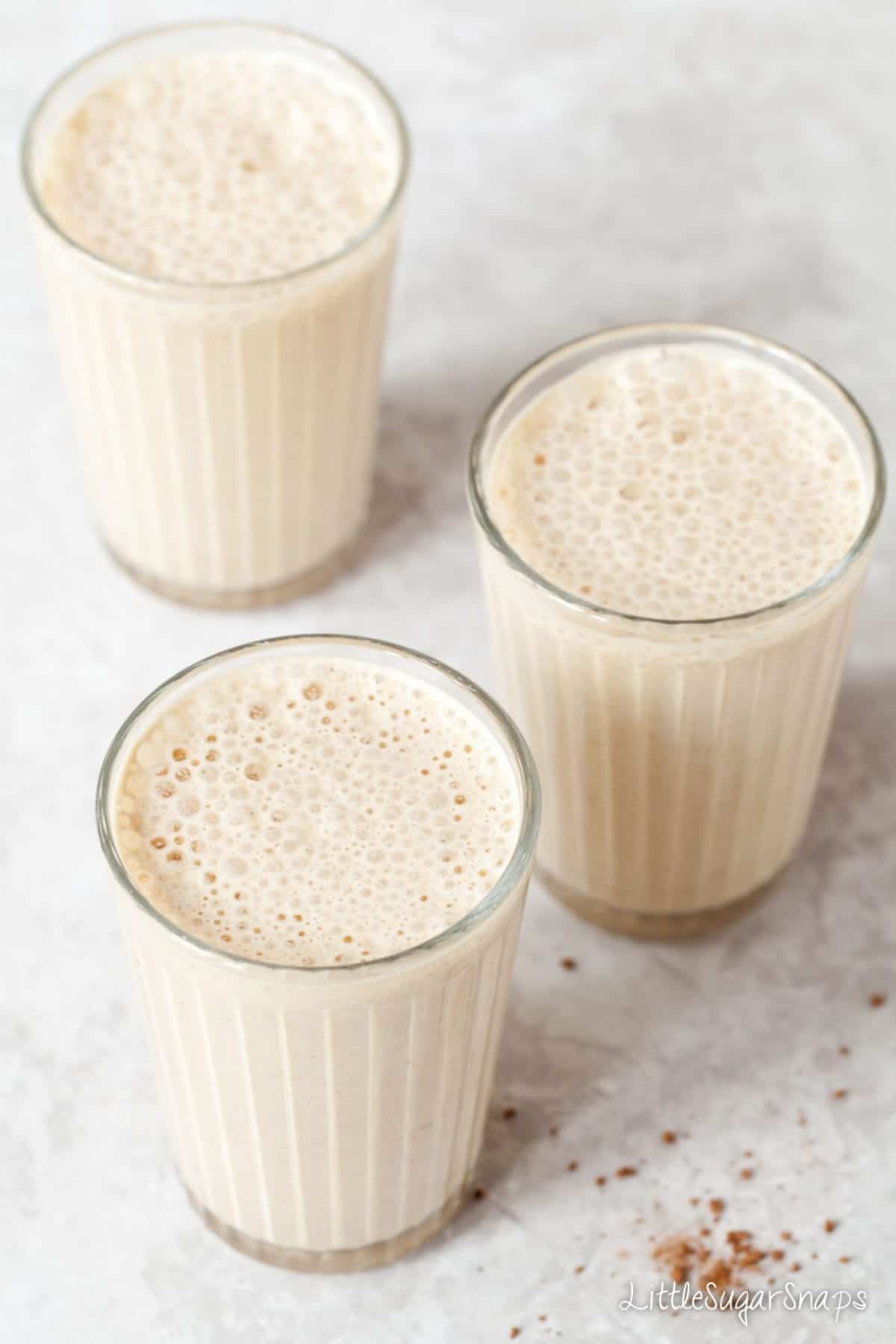 3 glasses of coffee milkshake on a worktop