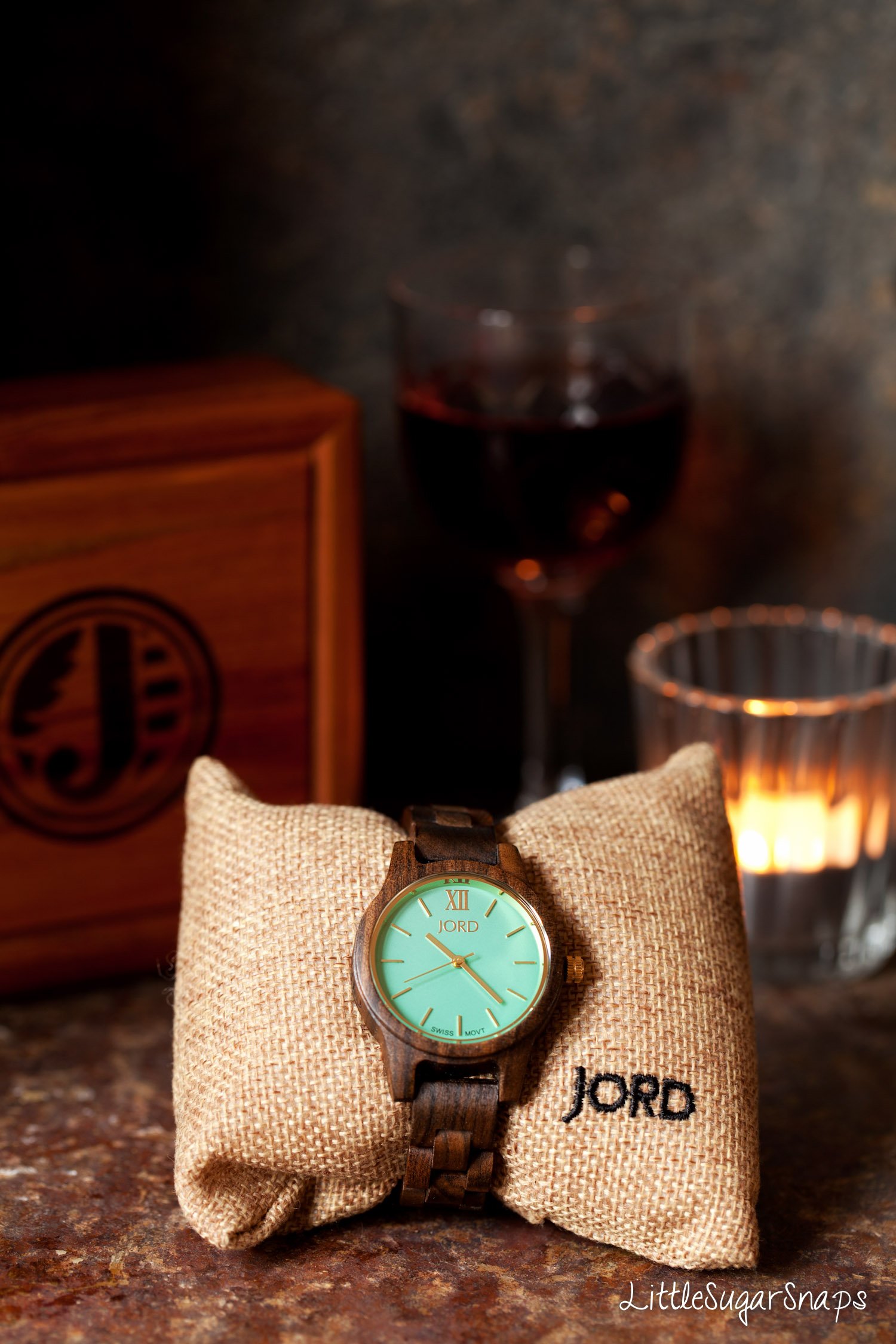 A wooden watch wrapped around a hessian pillow