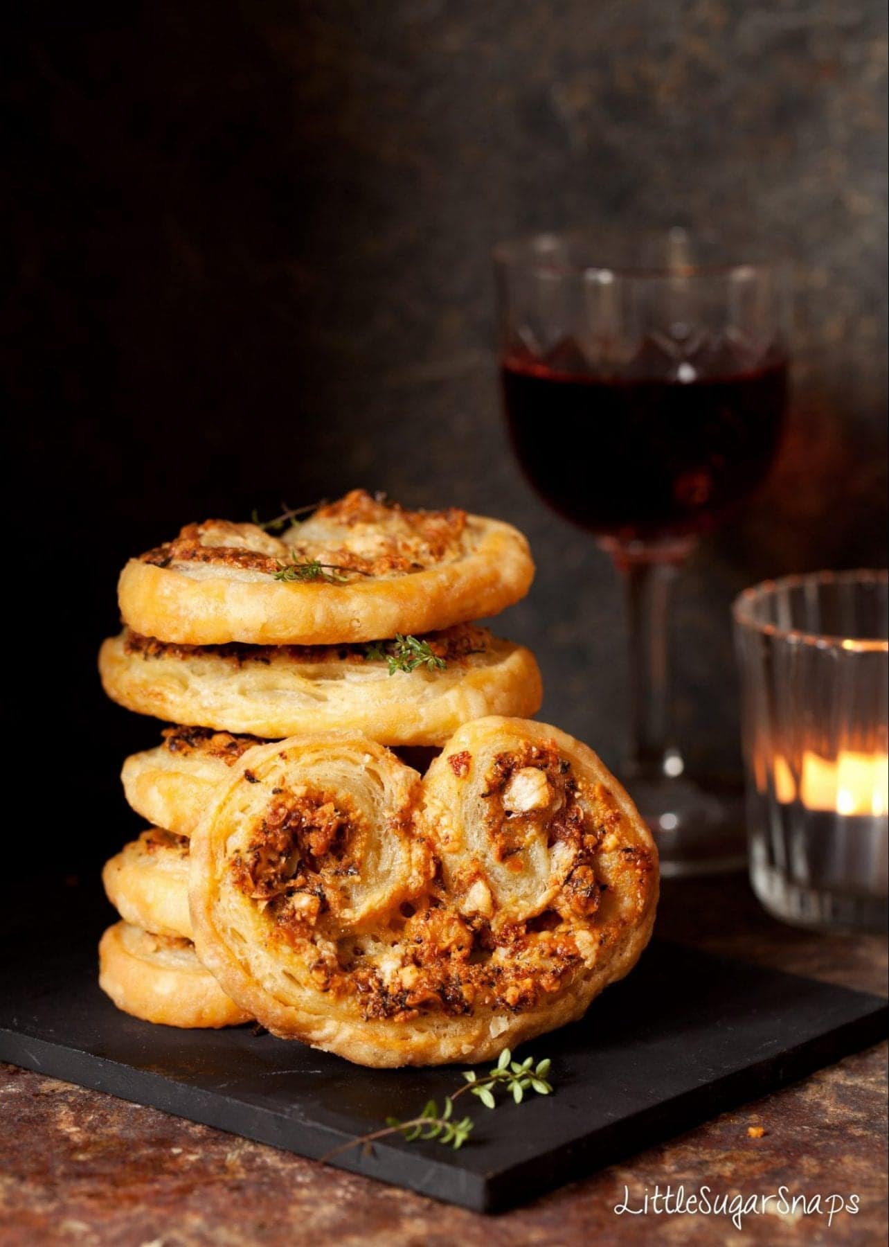 A stack of Cheese Palmiers on a slate board