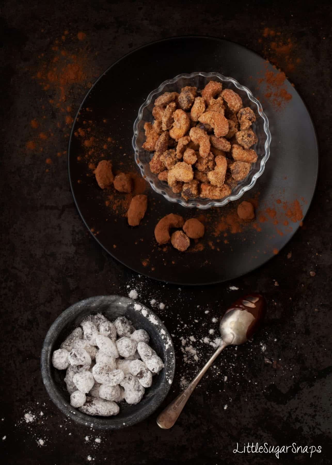 Spiced nuts, candied nuts and chocolate covered nuts served in small bowls