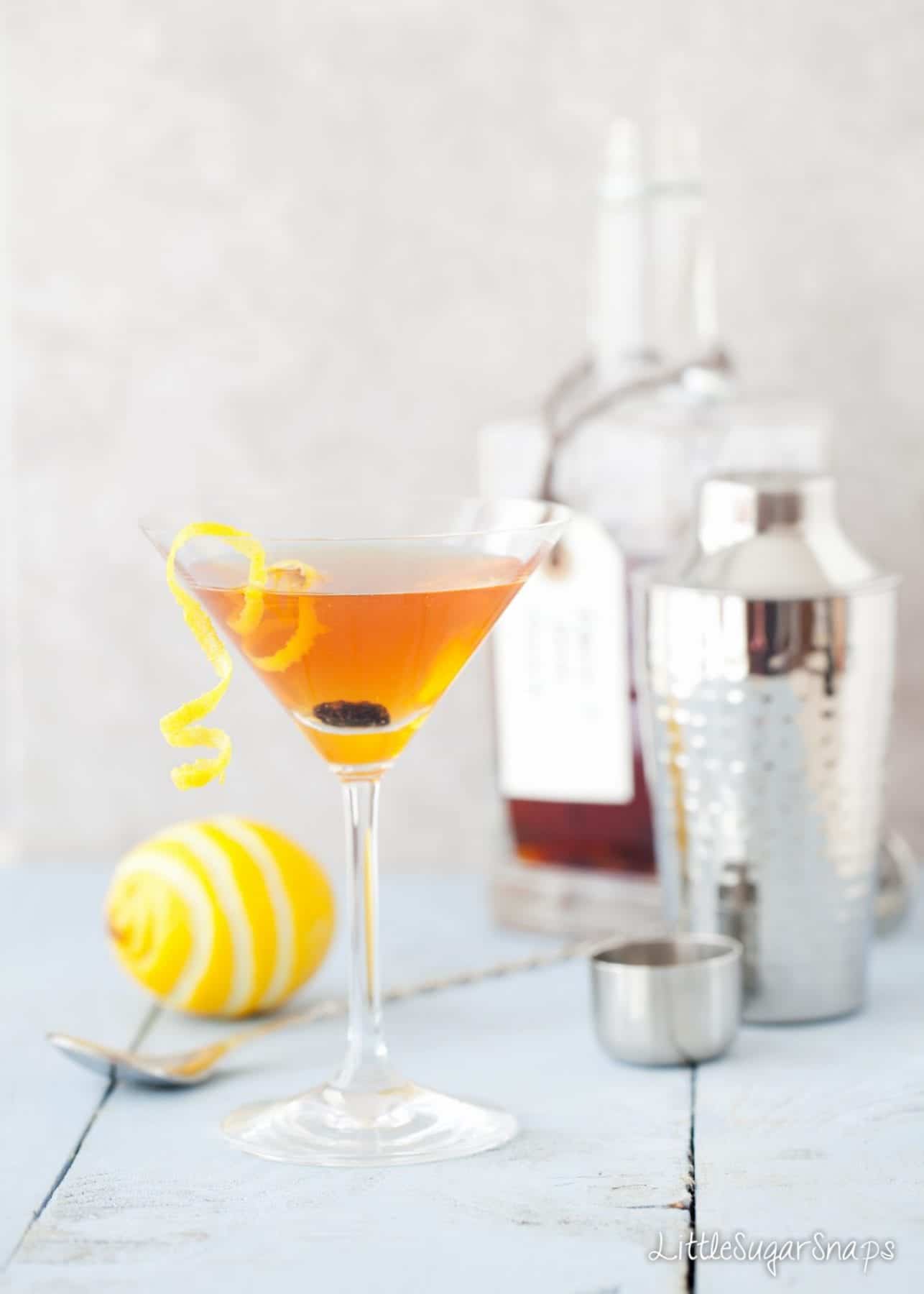 Hot Cross Bun Easter martini decorated with a lemon zest and raisins.