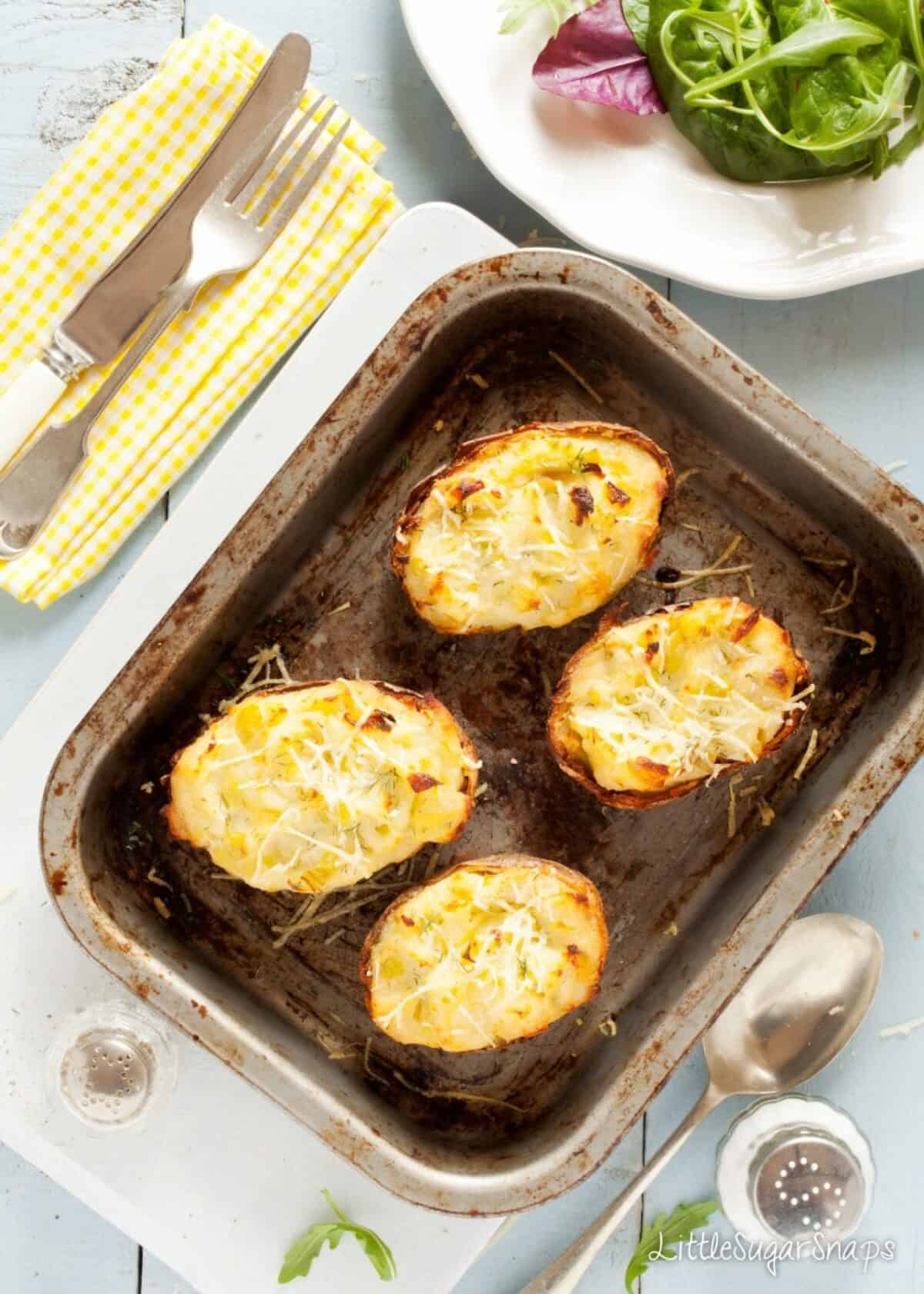 Four halves of Cheesy Leek Baked Potatoes just cooked.