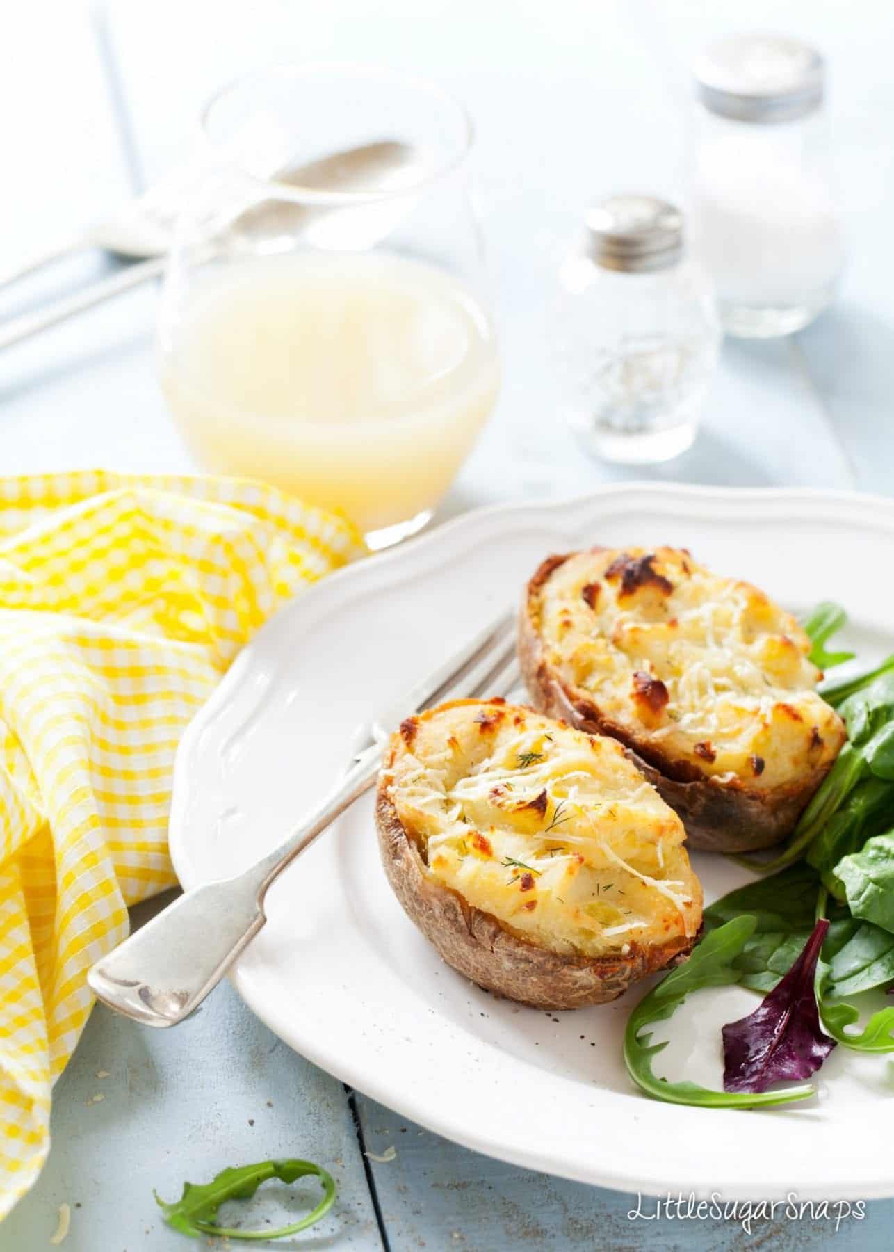 Cheesy Leek Baked Potatoes on a plate with salad.