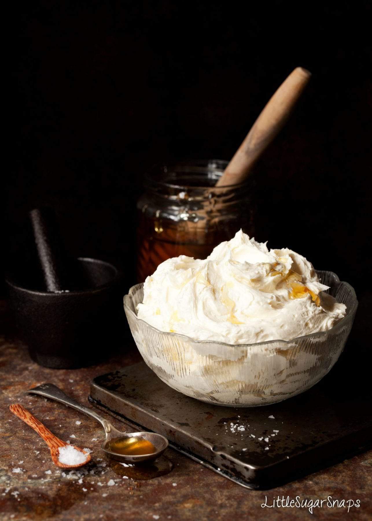 A bowl of honey frosting with salt and honey in shot
