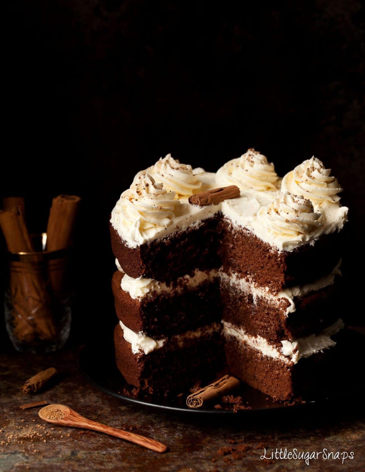 A cake cut into. Decorated with honey frosting 