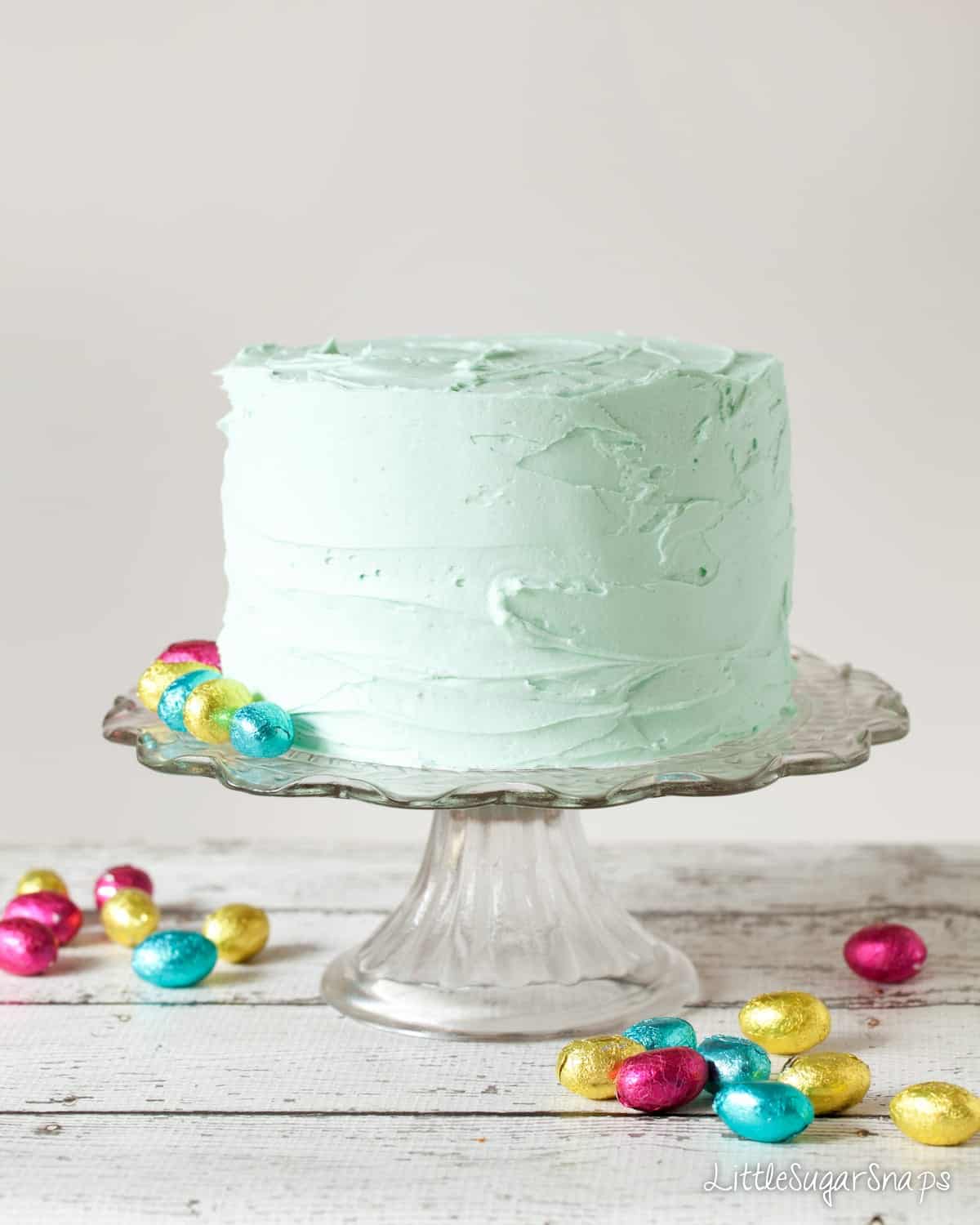 White chocolate easter cake recipe covered in pastel coloured peppermint buttercream 