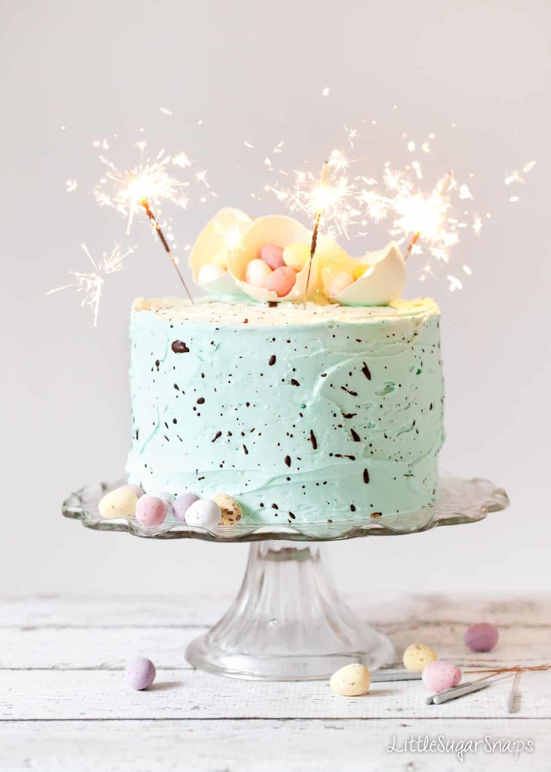 Easter cake recipe with mini eggs and sparklers for decoration.