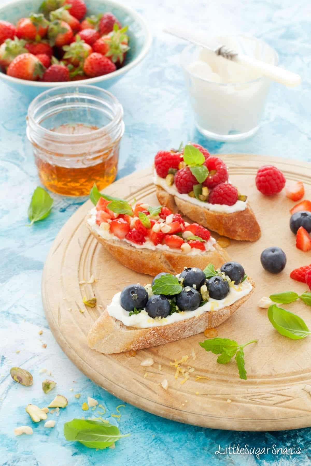 Mixed fruit breakfast bruschetta on a wooden platter