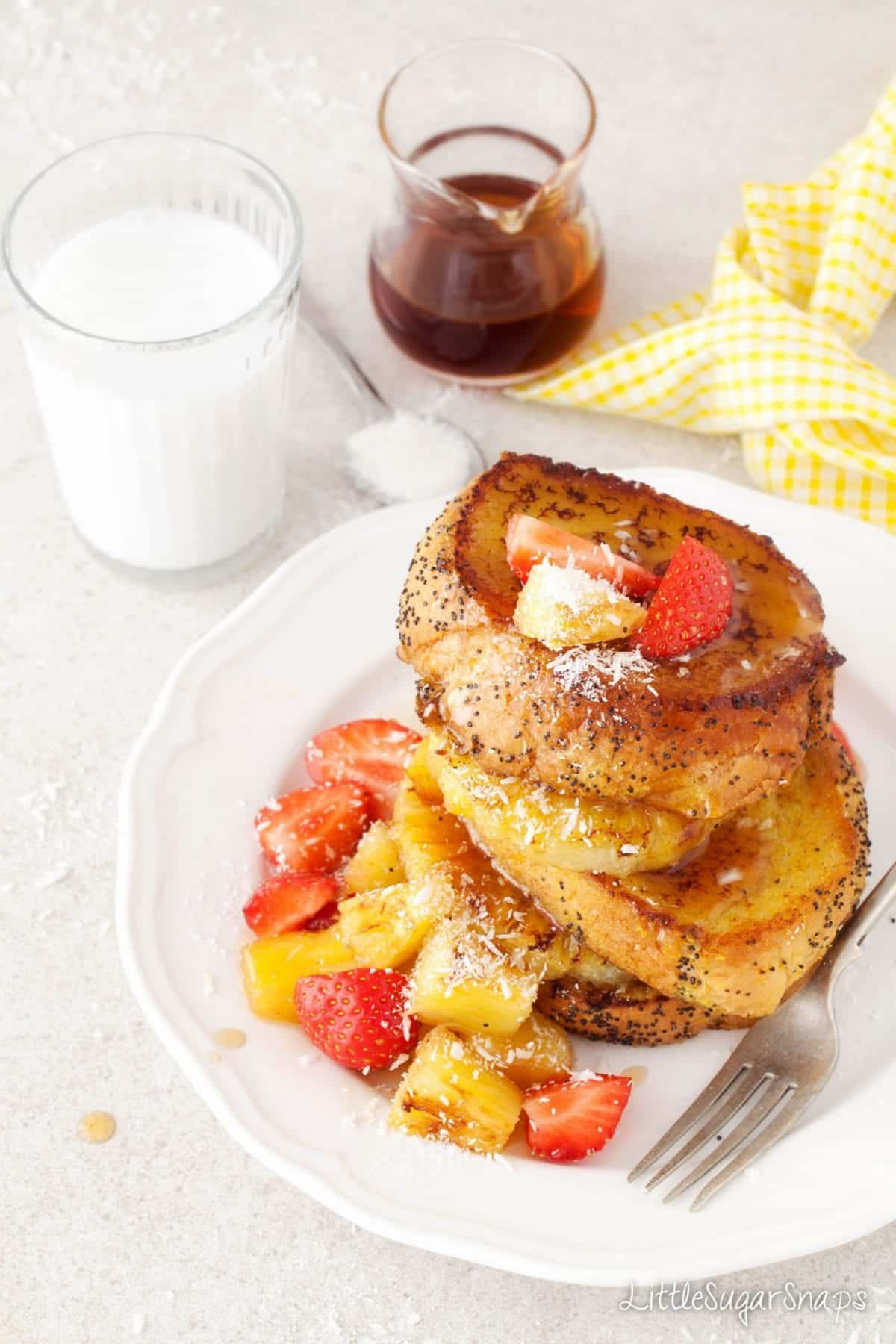 Vegan French Toast stacked up with fresh pineapple and strawberries