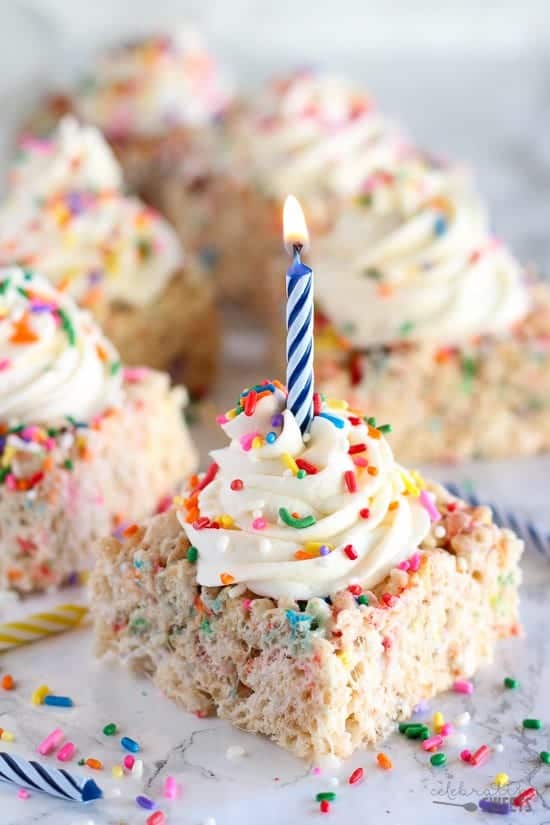 Funfetti krispie treats with buttercream and a lit candle