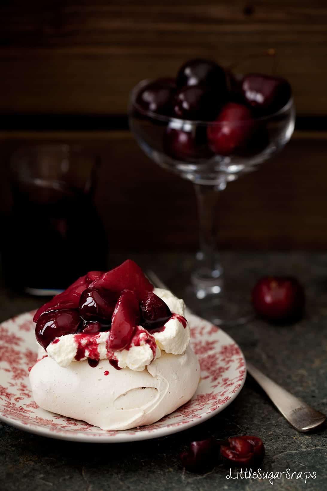 Muscovado Meringue with whipped cream and red wine poached fruit.