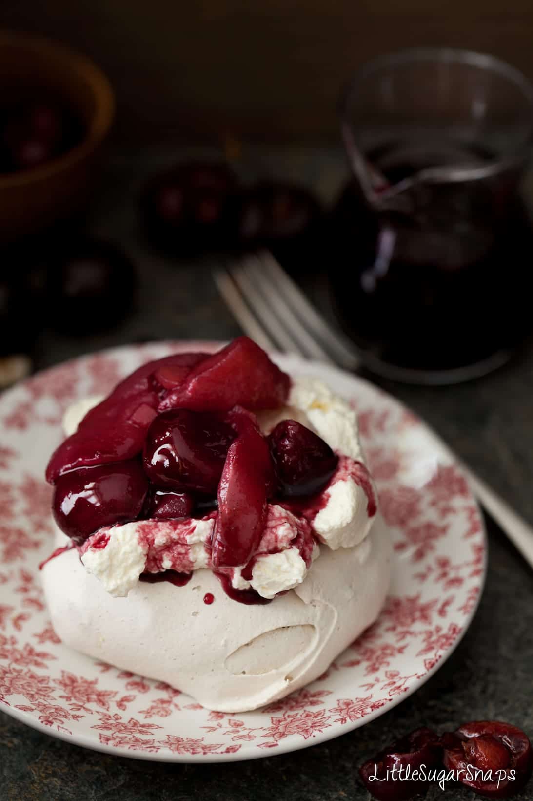 Close up of mini pavlova with poached fruit and cream