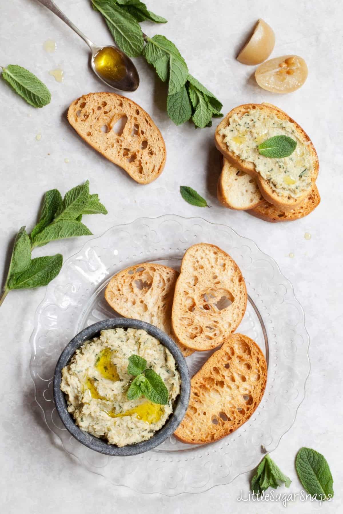 Preserved Lemon & Mint Hummus served in a bowl with toasted bread alongside. 
