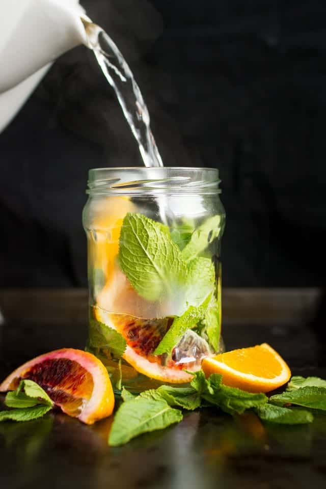 Orange and mint tea being poured