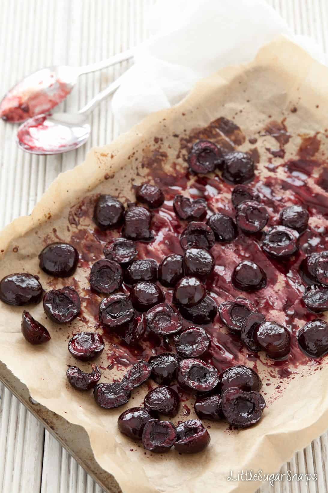 Roasted Cherries on a parchment lined baking sheet