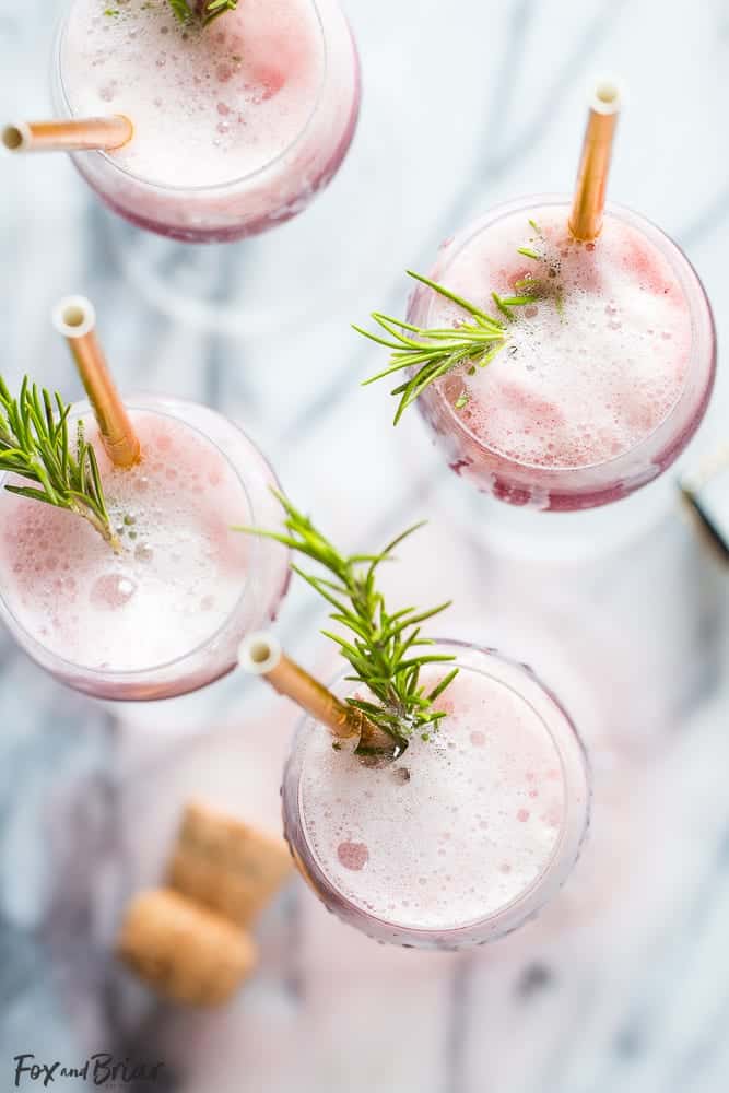 Overhead view of raspberry sorbet mimosa with rosemary