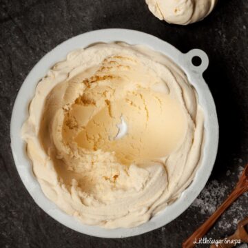 Salted honey ice cream in a pot with some scooped out