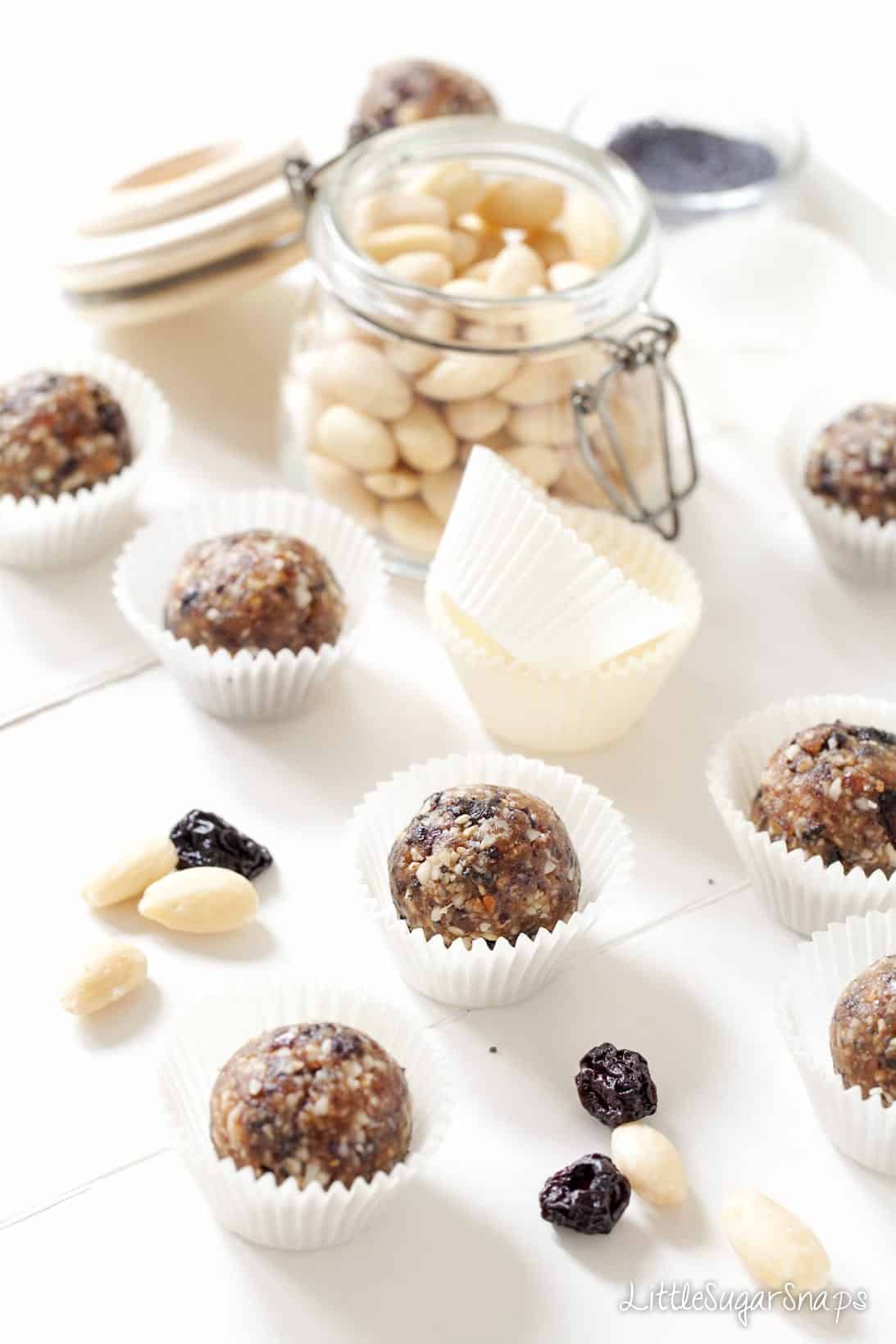 Cherry Bakewell Almond Energy Balls and blanched almonds alongside.