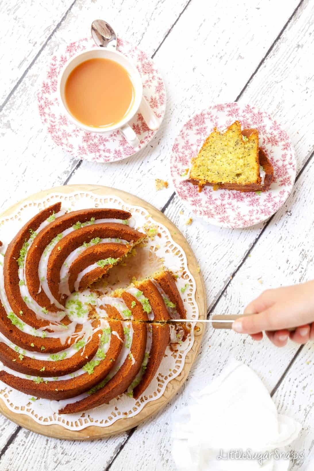 Zucchini Lime Pistachio Cake bundt cake being cut and served