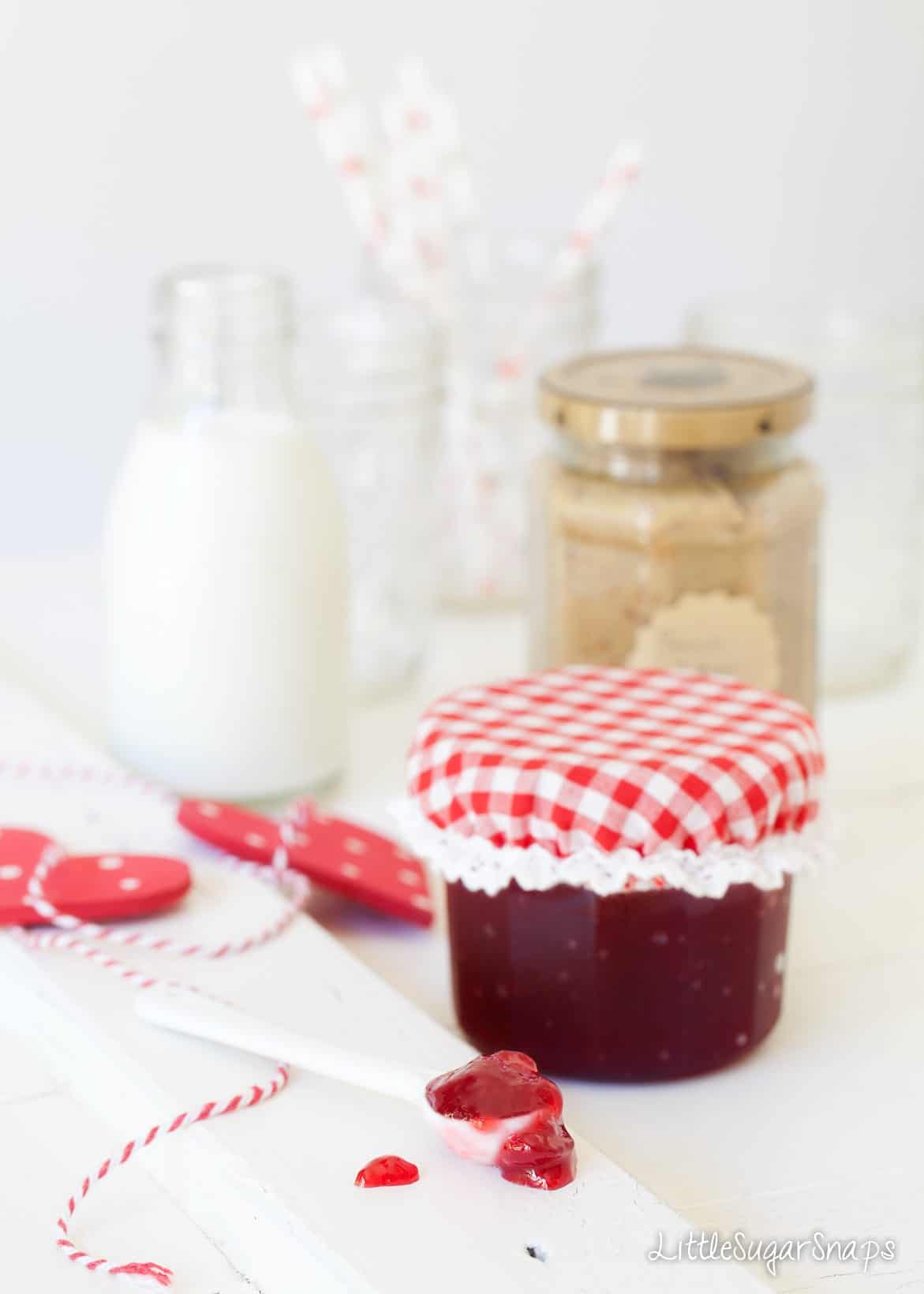 Jam, peanut butter and milk in jars.