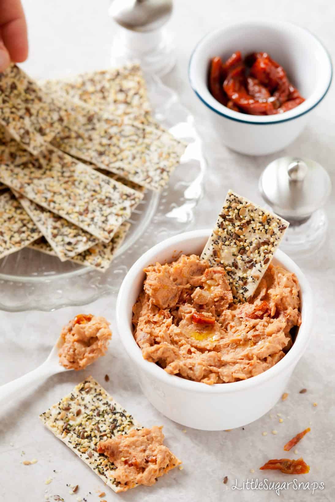 Sundried Tomato White Bean Dip in a bowl with crackers