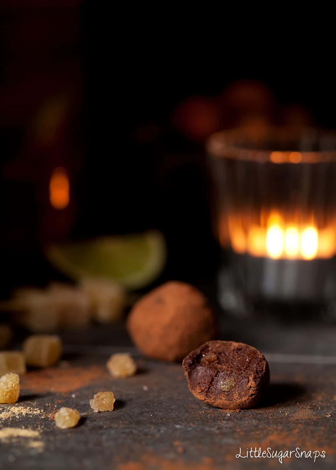 A bitten into Ginger Truffle chocolate with pieces of crystallised ginger inside.