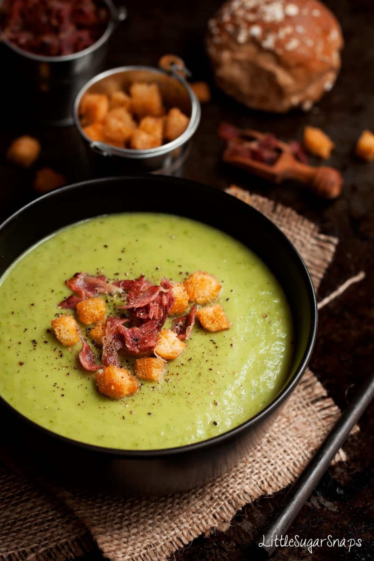 A Bowl of Celeriac soup with croutons, crispy bacon and cracked black pepper.