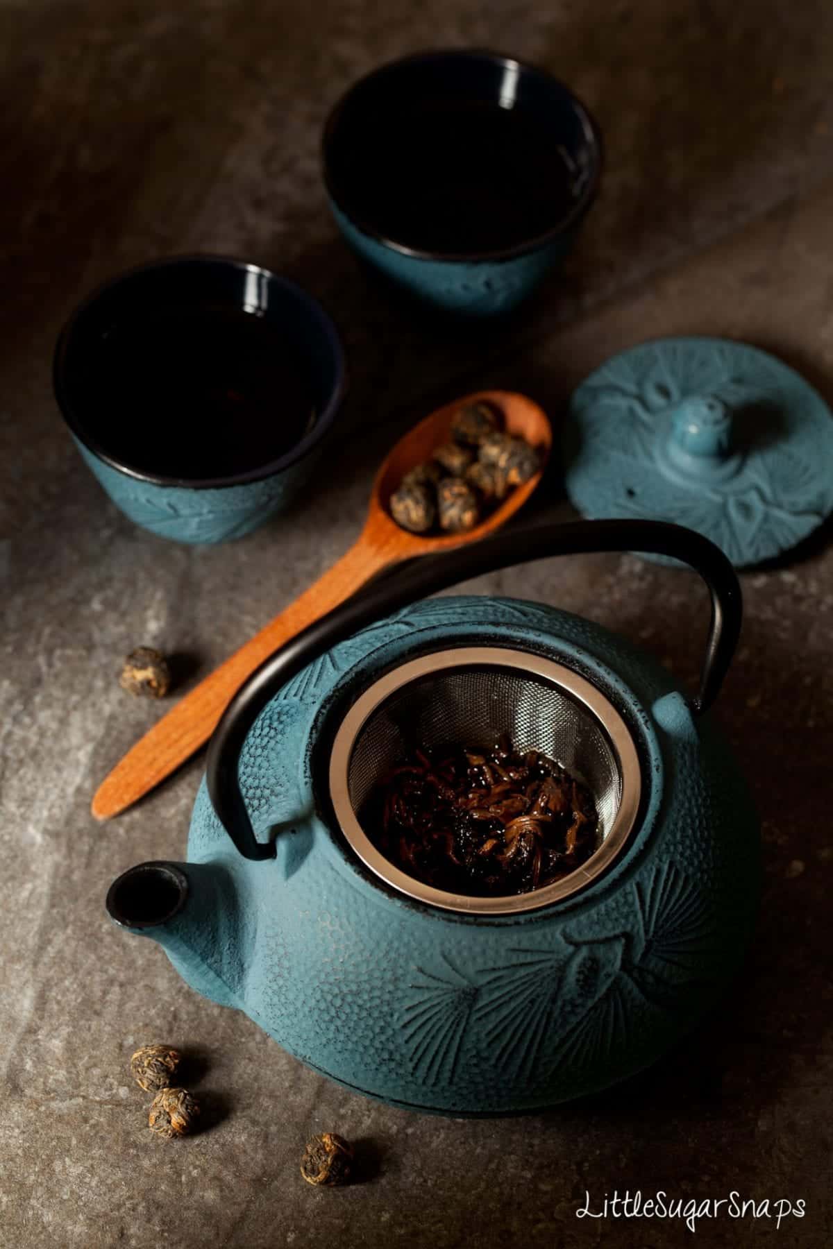 Tea brewing in a blue cast iron teapot.