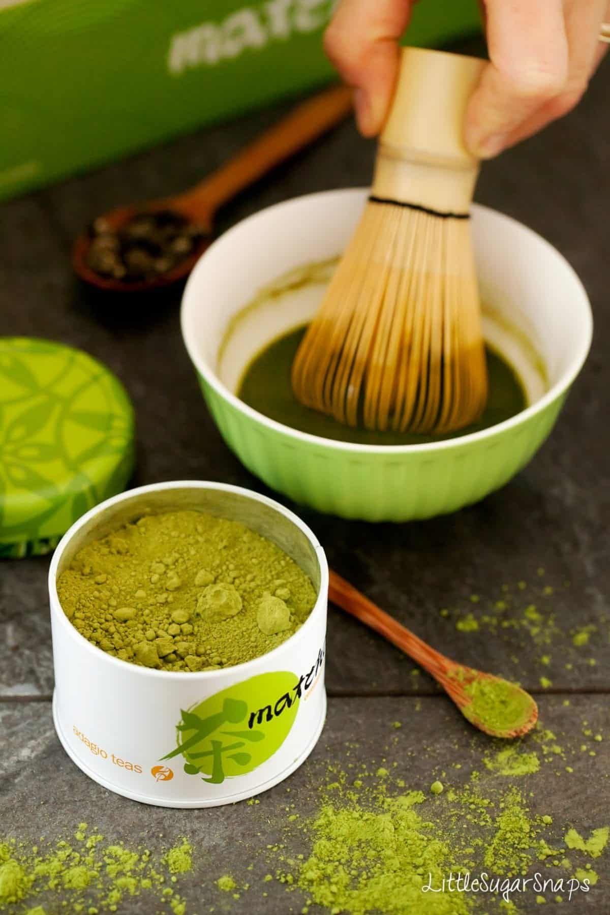 Person brewing matcha tea using a matcha teaset.