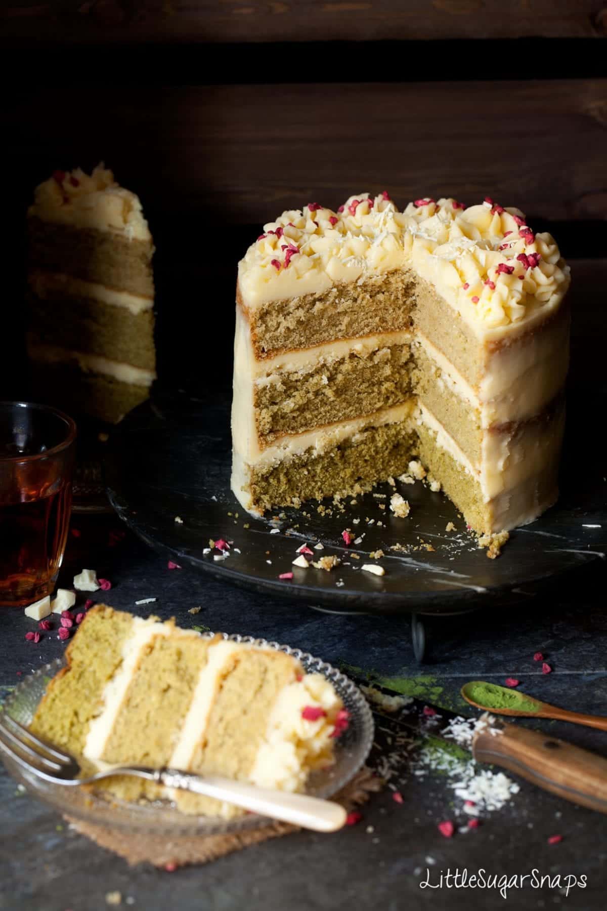 Matcha Ombre Cake with several pieces cut and removed to reveal the layers.