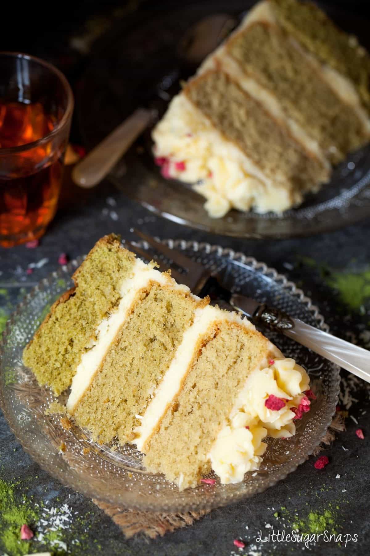 A slice of ombre Matcha Cake on a glass plate