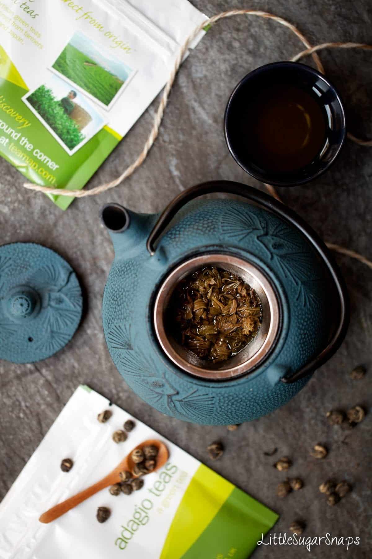 Tea brewing in a blue cast iron teapot.