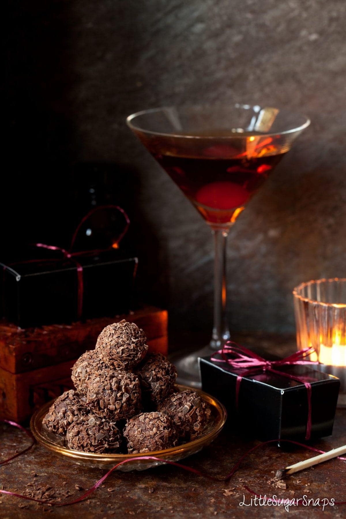 Manhattan Truffles covered in chocolate flakes on a decorative plate.