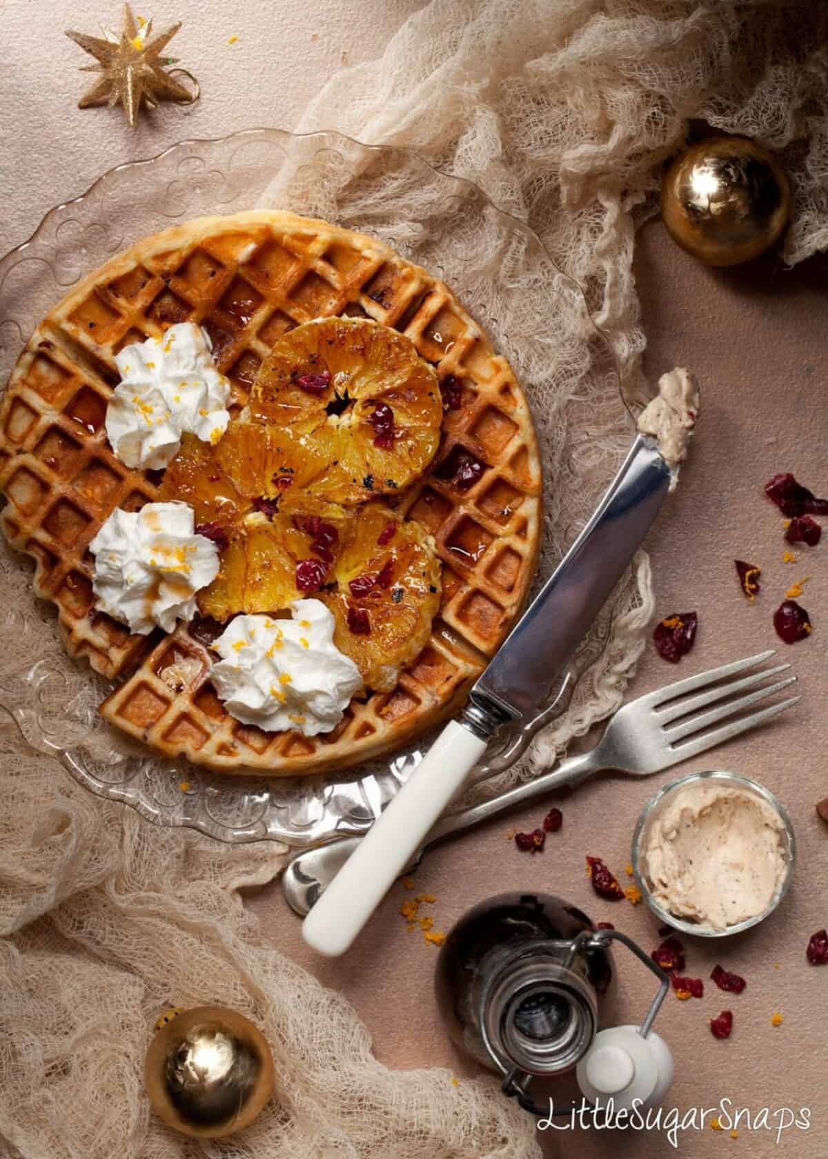 Waffles with griddled orange slices and dried cranberries.